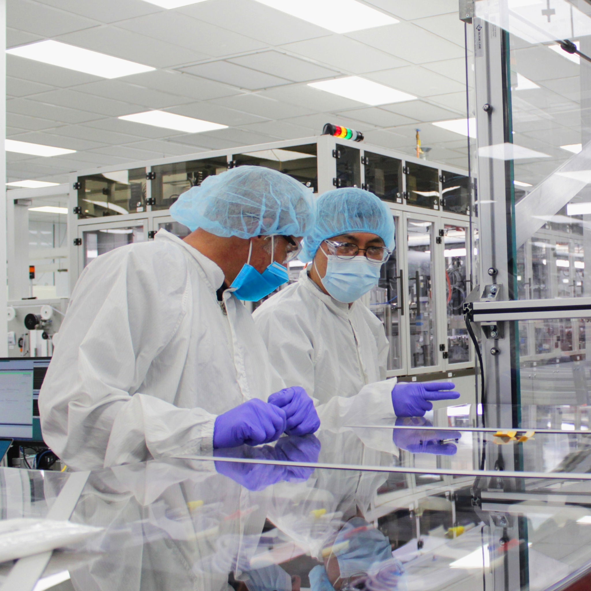 Two researchers in a factory facility