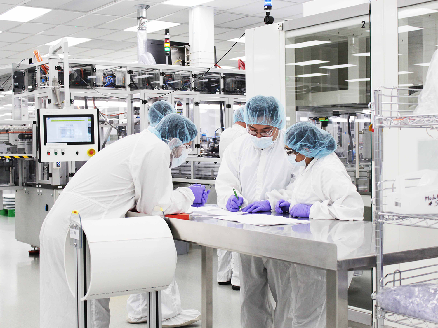 Workers collaborating in the clean room at our Littleton CO facility