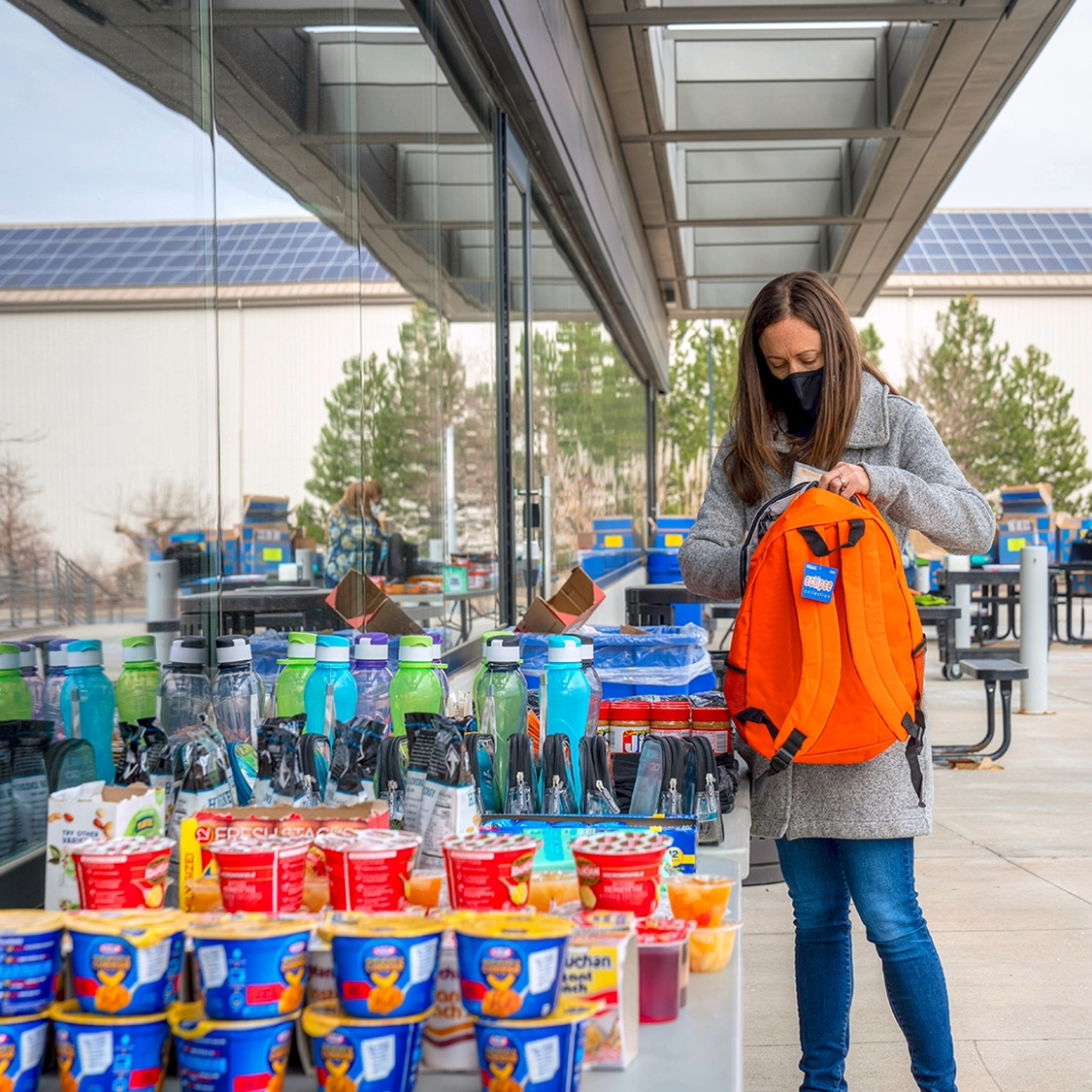 a volunteer loading a backpack with supplies