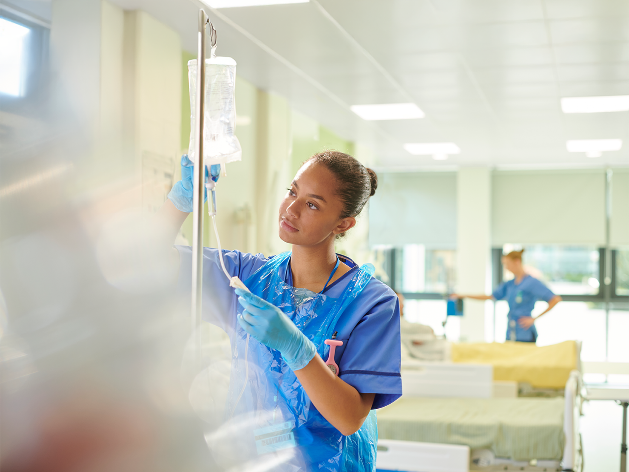 healthcare provider hanging a solution bag