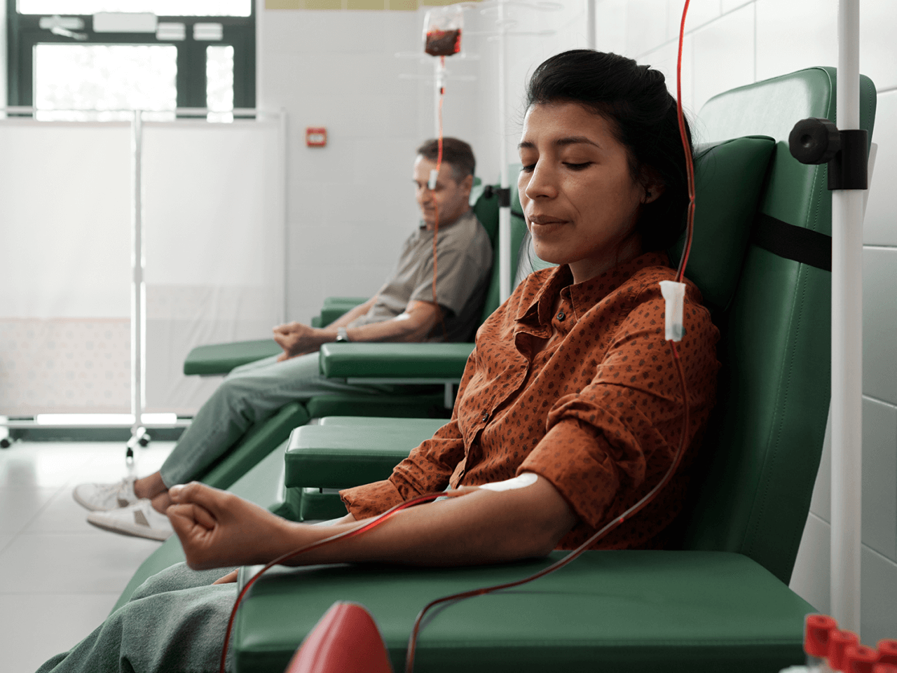 Two people donating blood